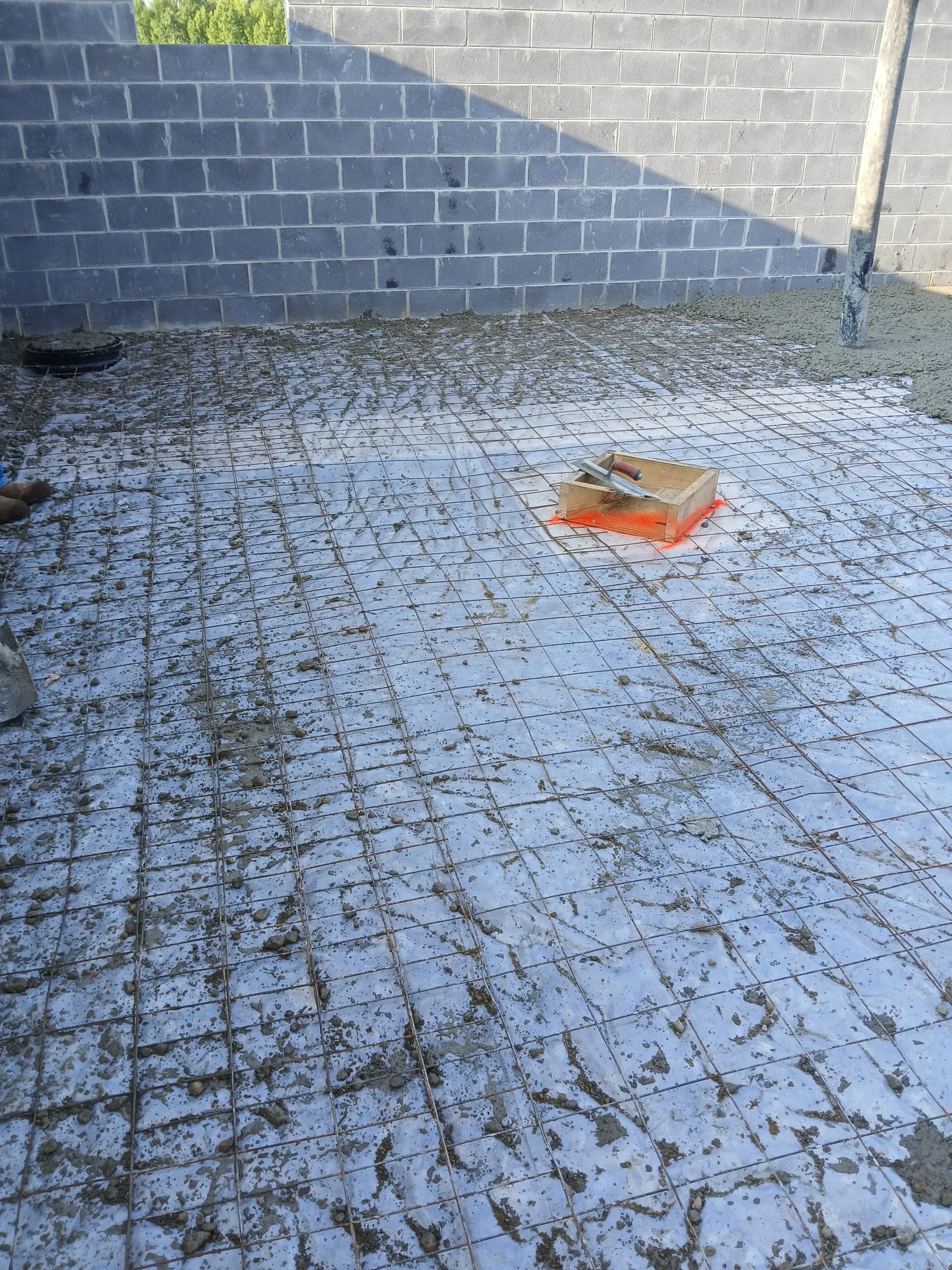 Pressure washing concrete pool deck with algae and mold removal, light blue tile surface restoration