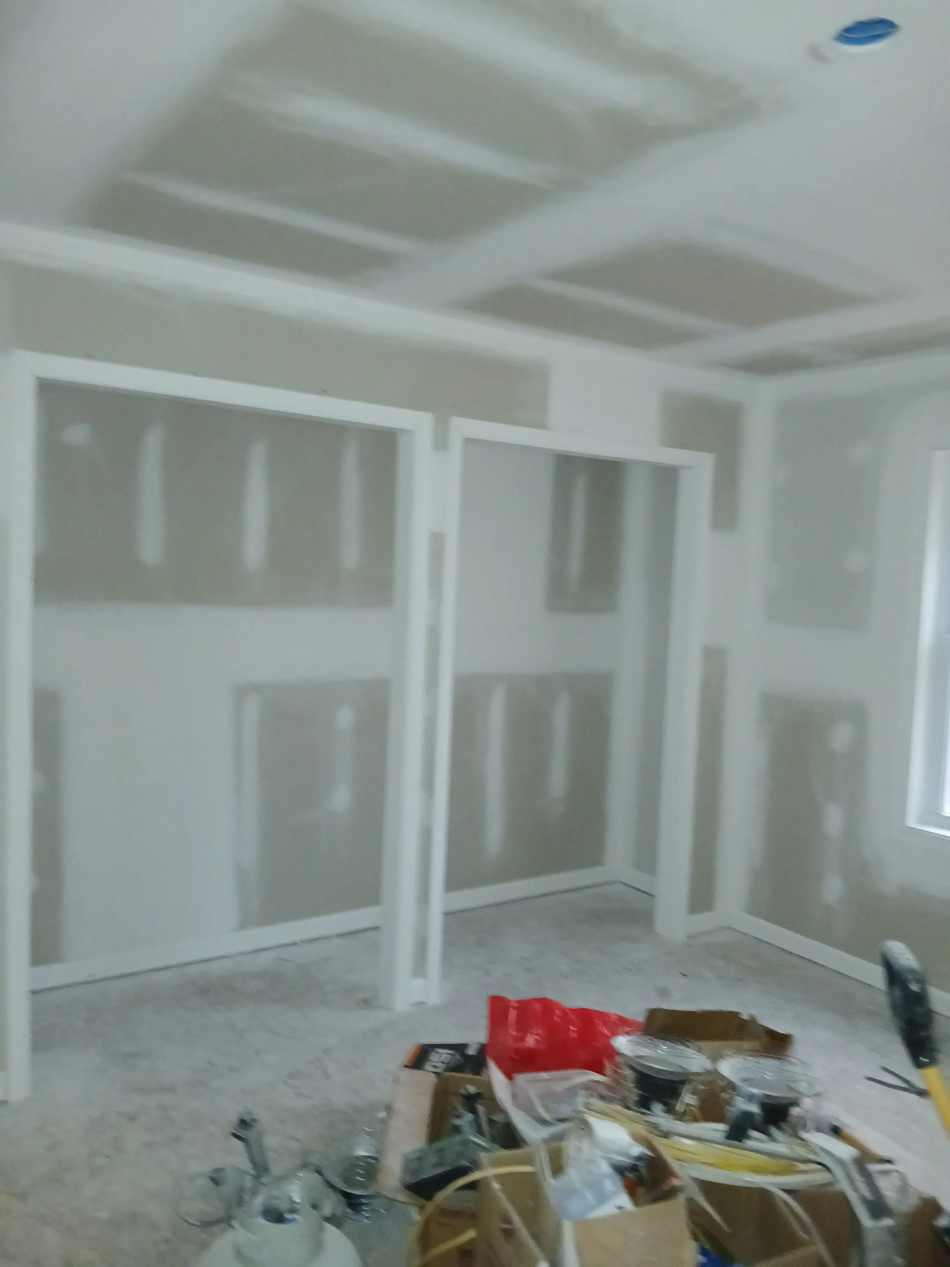 Metal stud framing with drywall installation and recessed lighting preparation