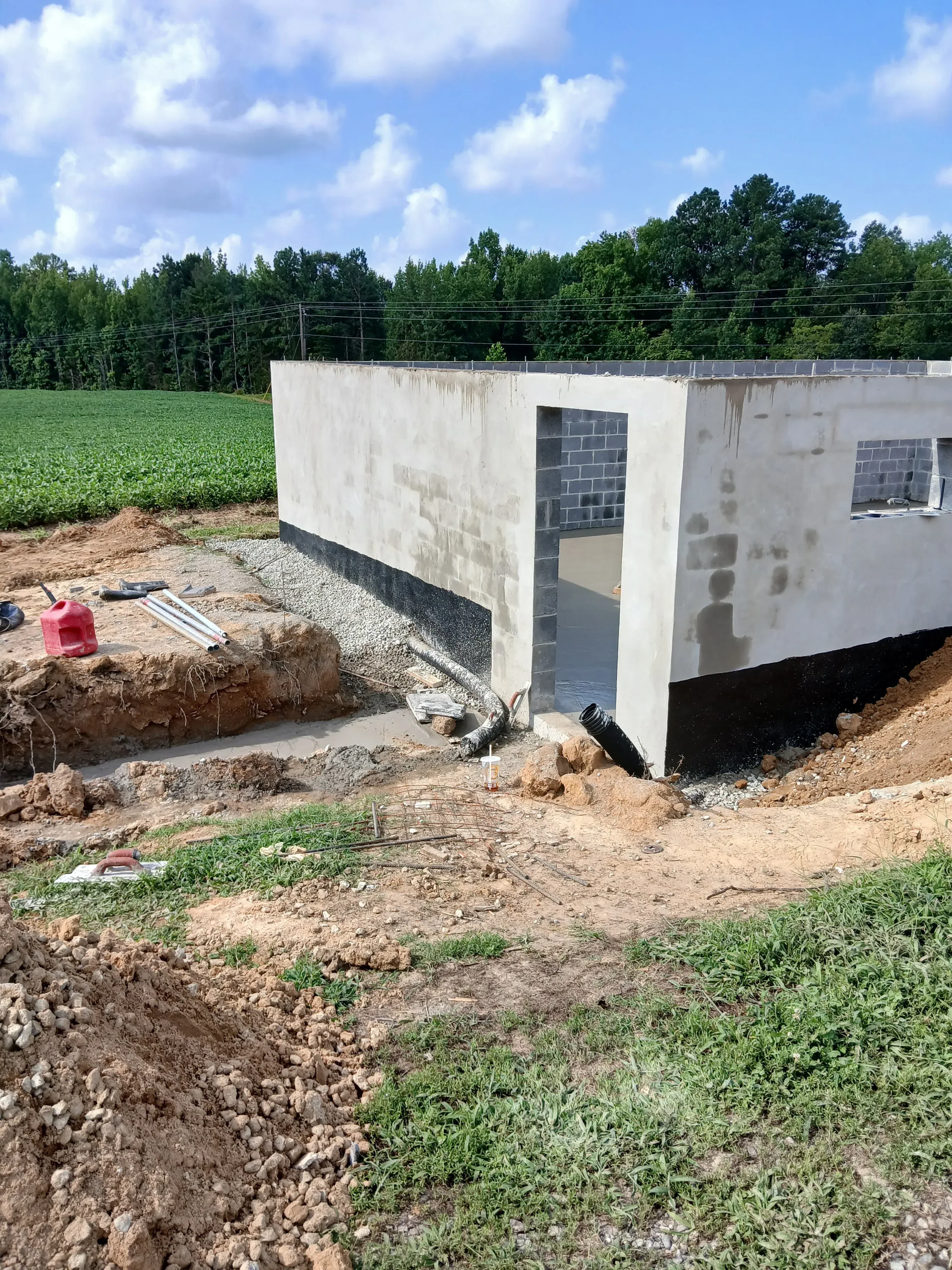 Concrete foundation repair with excavated soil and gravel base preparation