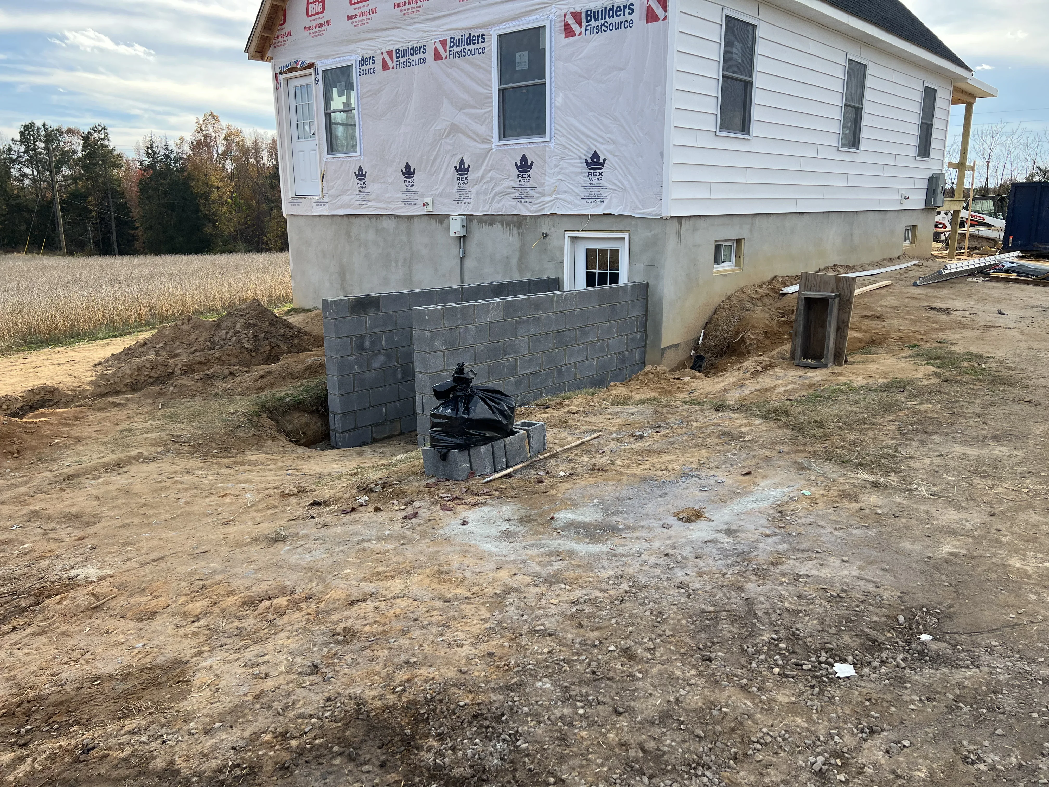 Concrete block foundation wall with basement egress window opening during construction